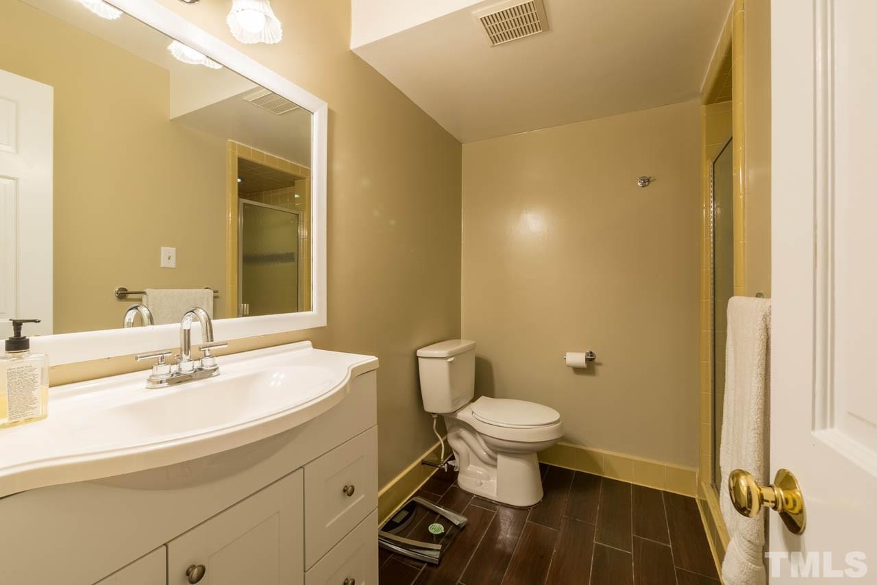 1700 Tropical Drive Raleigh, NC 27607 - Photo 15 of 25 a bathroom with a sink and a mirror