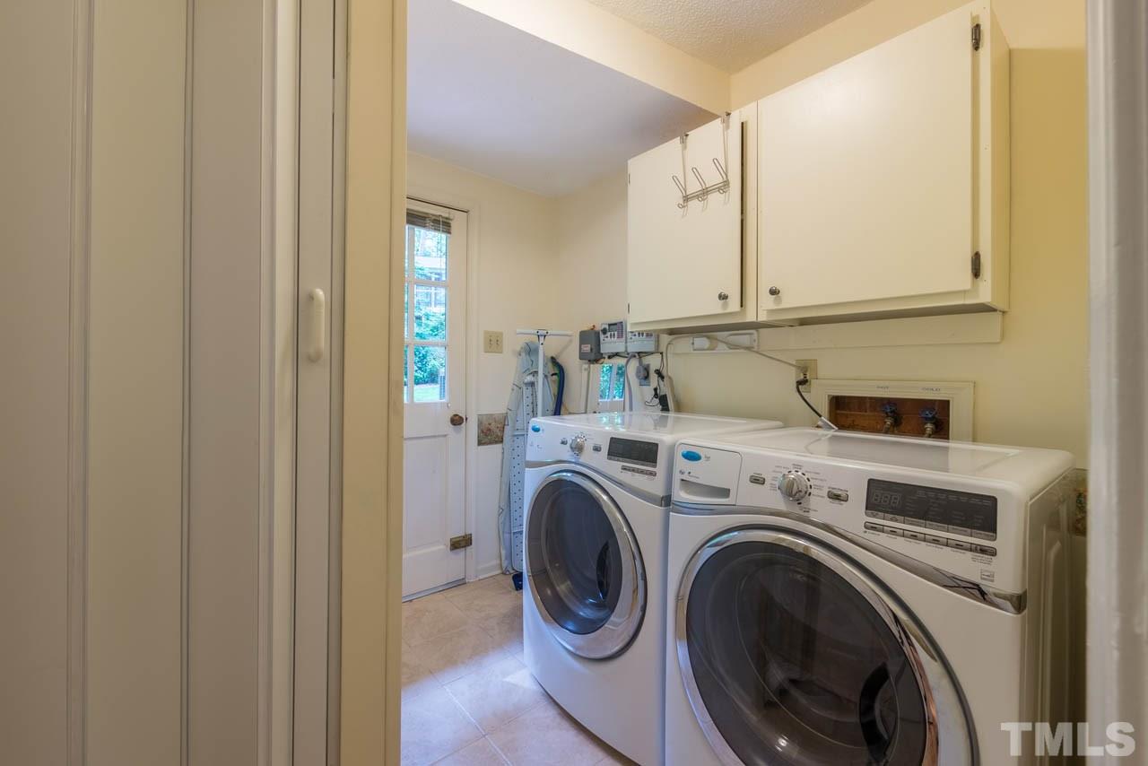 1700 Tropical Drive Raleigh, NC 27607 - Photo 16 of 25 a view of storage and utility room with washer and dryer