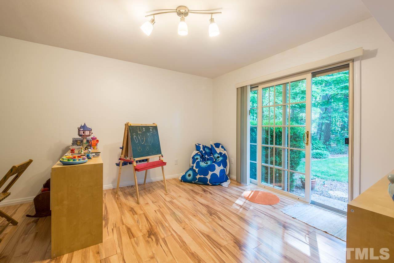 1700 Tropical Drive Raleigh, NC 27607 - Photo 17 of 25 a bedroom with a bed and large windows