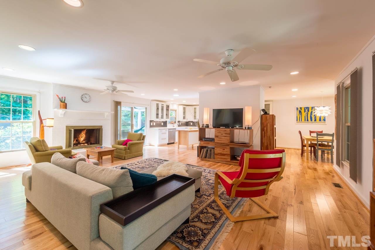 1700 Tropical Drive Raleigh, NC 27607 - Photo 4 of 25 a living room with fireplace furniture and a wooden floor