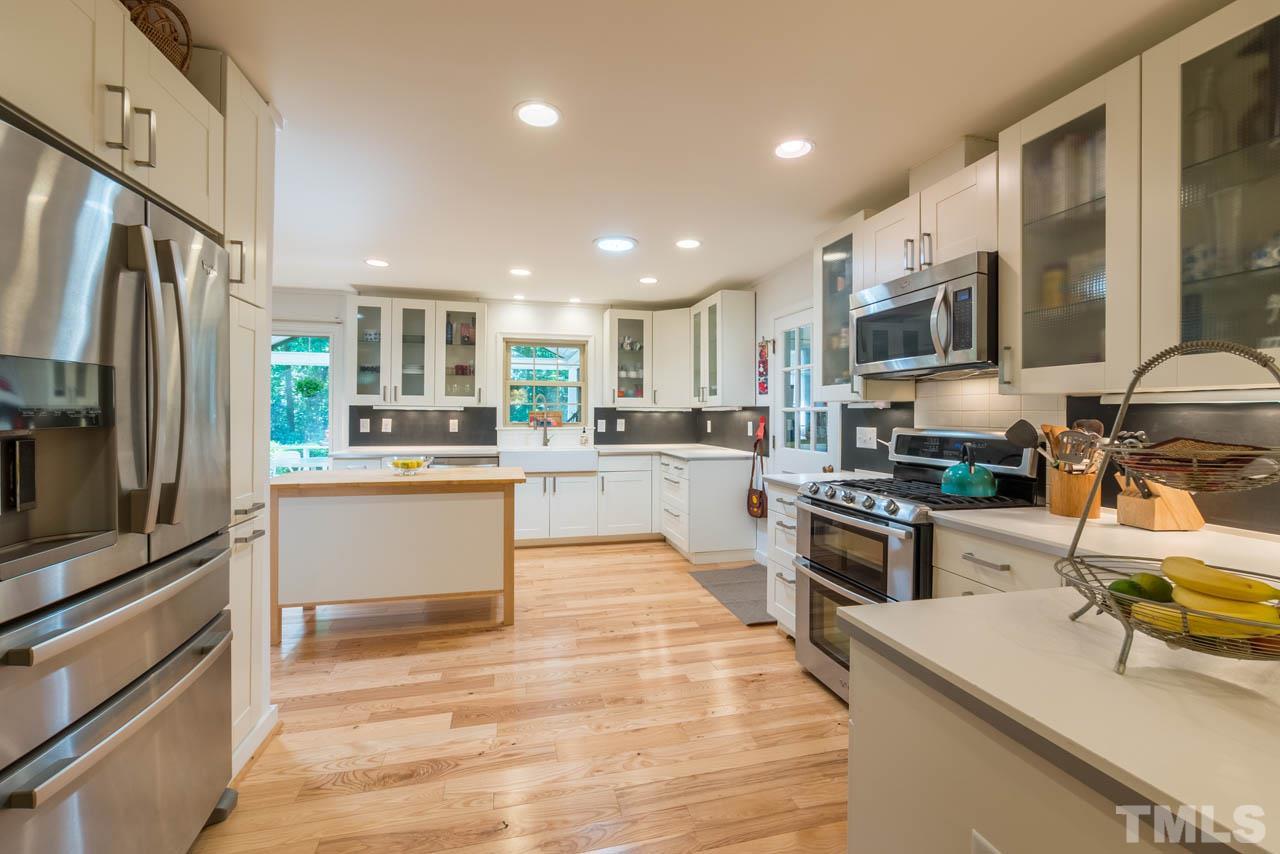 1700 Tropical Drive Raleigh, NC 27607 - Photo 6 of 25 a kitchen with stainless steel appliances granite countertop a refrigerator sink and stove