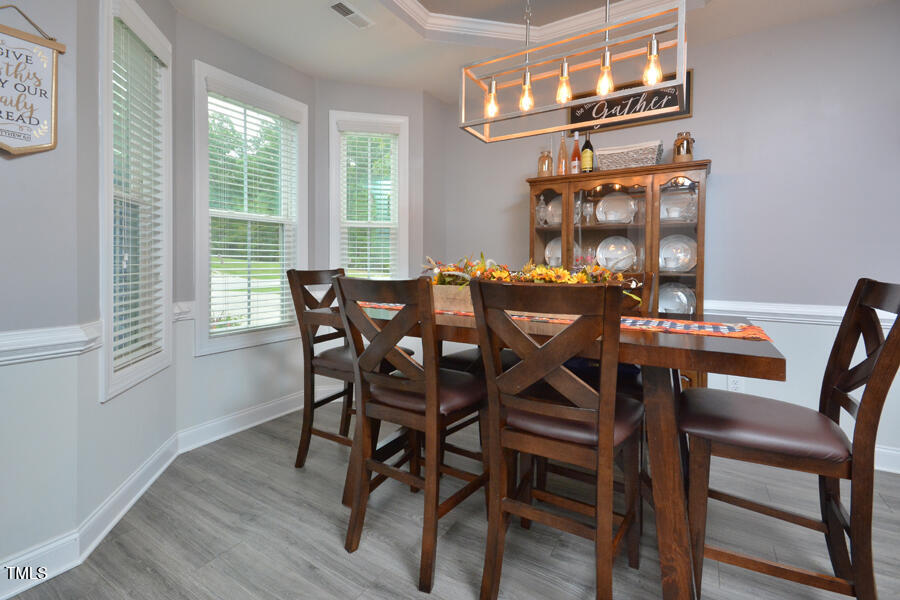 195 Timberwind Road Franklinton, NC 27525 - Photo 5 of 28 a view of a dining room with furniture a chandelier and wooden floor