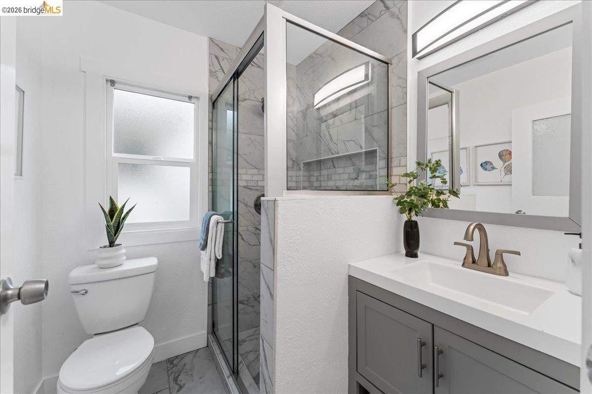 2717 Mabel Street Berkeley, CA 94702 - Photo 19 of 60 Bathroom featuring vanity, a marble finish shower, and light marble finish floors