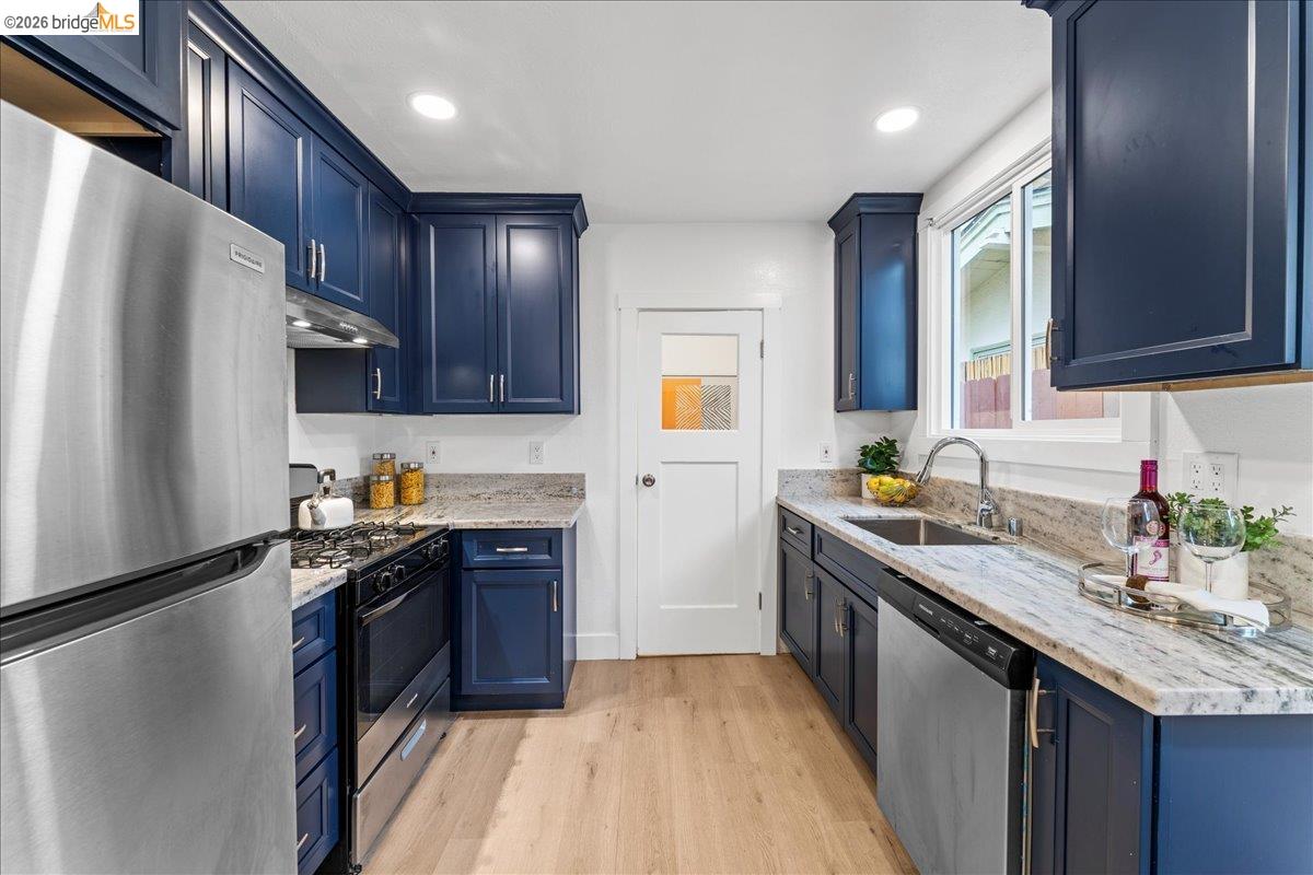2717 Mabel Street Berkeley, CA 94702 - Photo 25 of 60 a kitchen with stainless steel appliances granite countertop a sink stove and refrigerator
