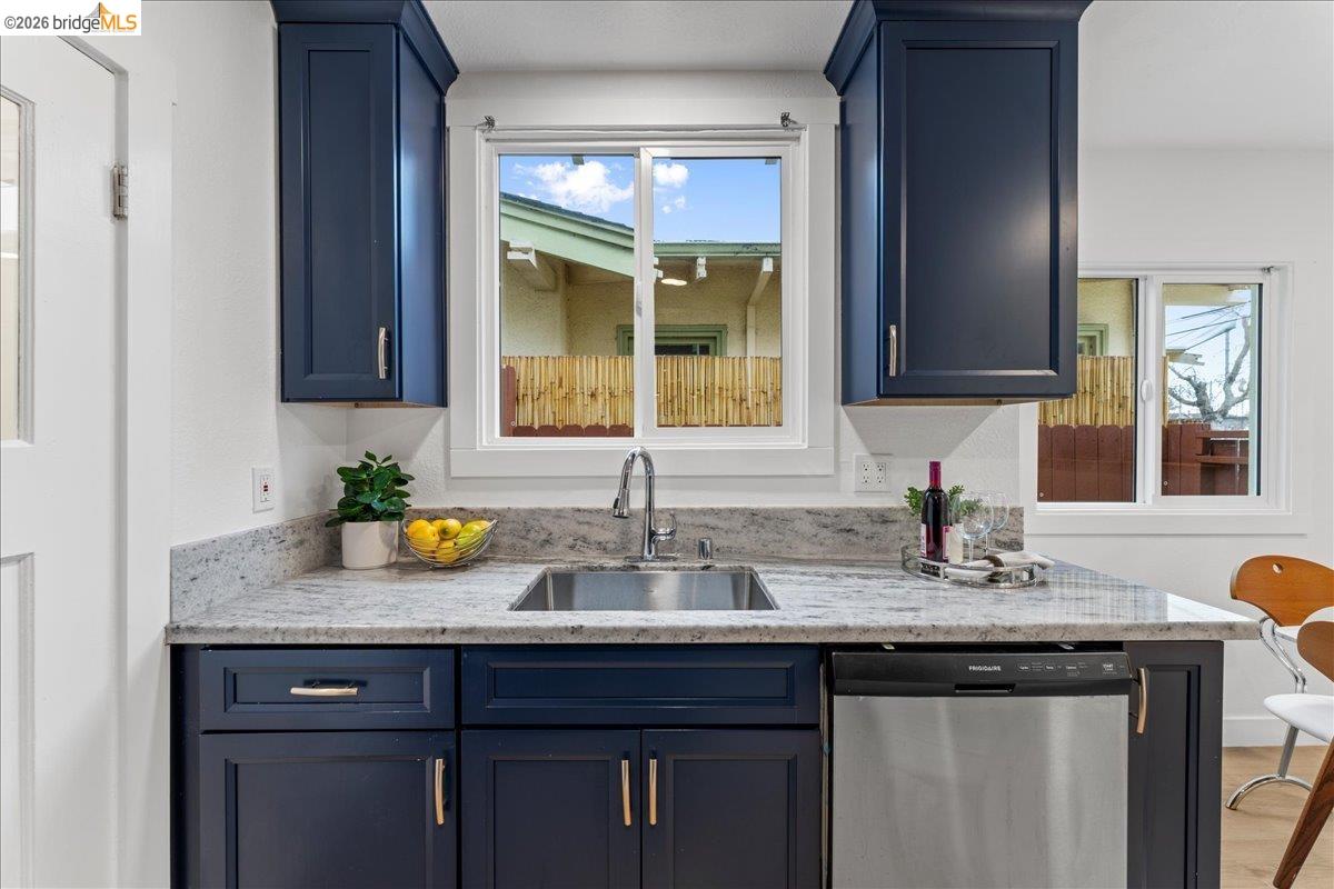 2717 Mabel Street Berkeley, CA 94702 - Photo 27 of 60 a kitchen with granite countertop a sink stainless steel appliances and cabinets