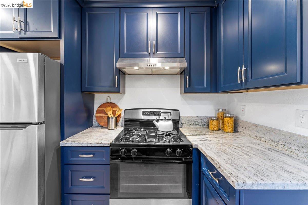 2717 Mabel Street Berkeley, CA 94702 - Photo 28 of 60 a kitchen with granite countertop stainless steel appliances and wooden cabinets