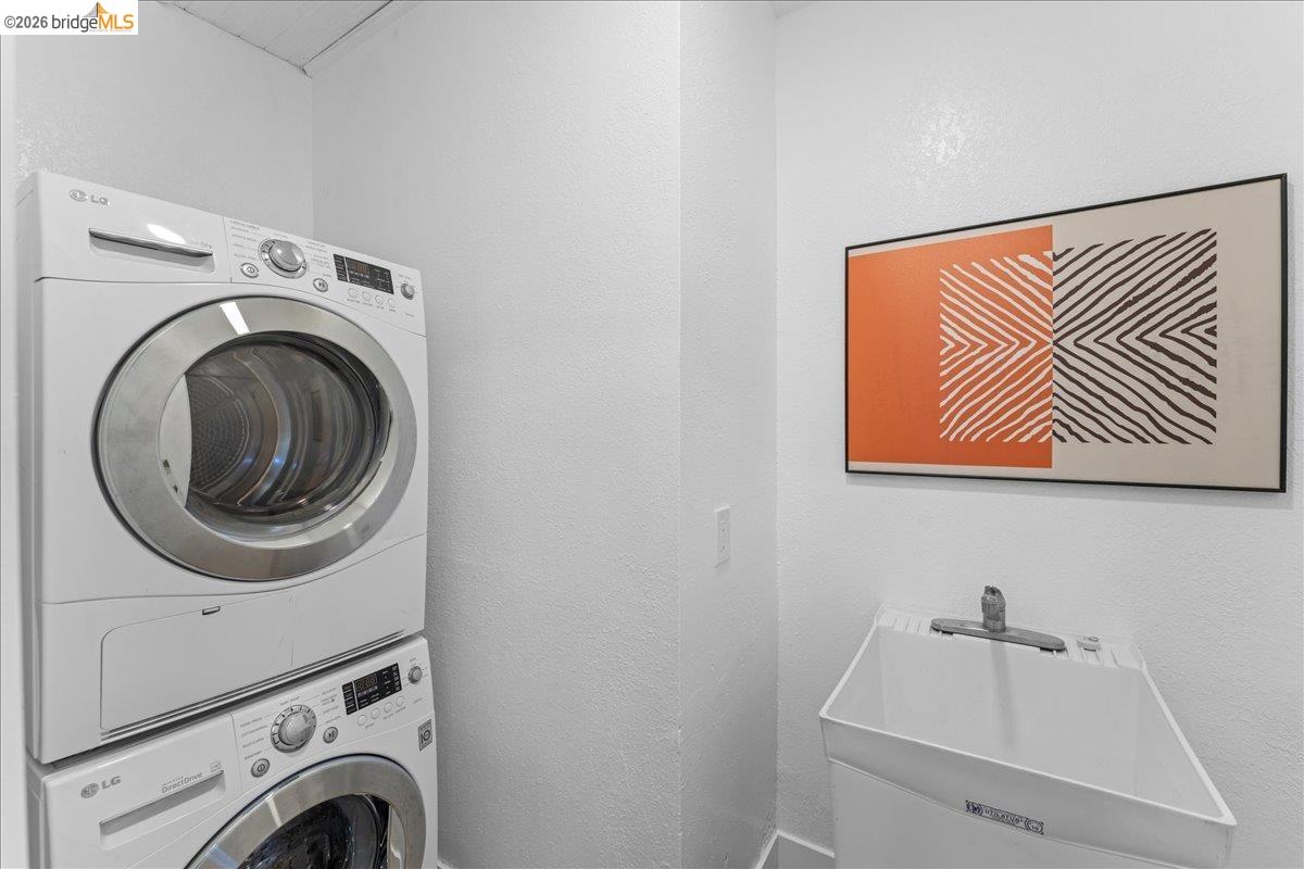 2717 Mabel Street Berkeley, CA 94702 - Photo 30 of 60 Laundry area with estacked washer and dryer and a textured wall