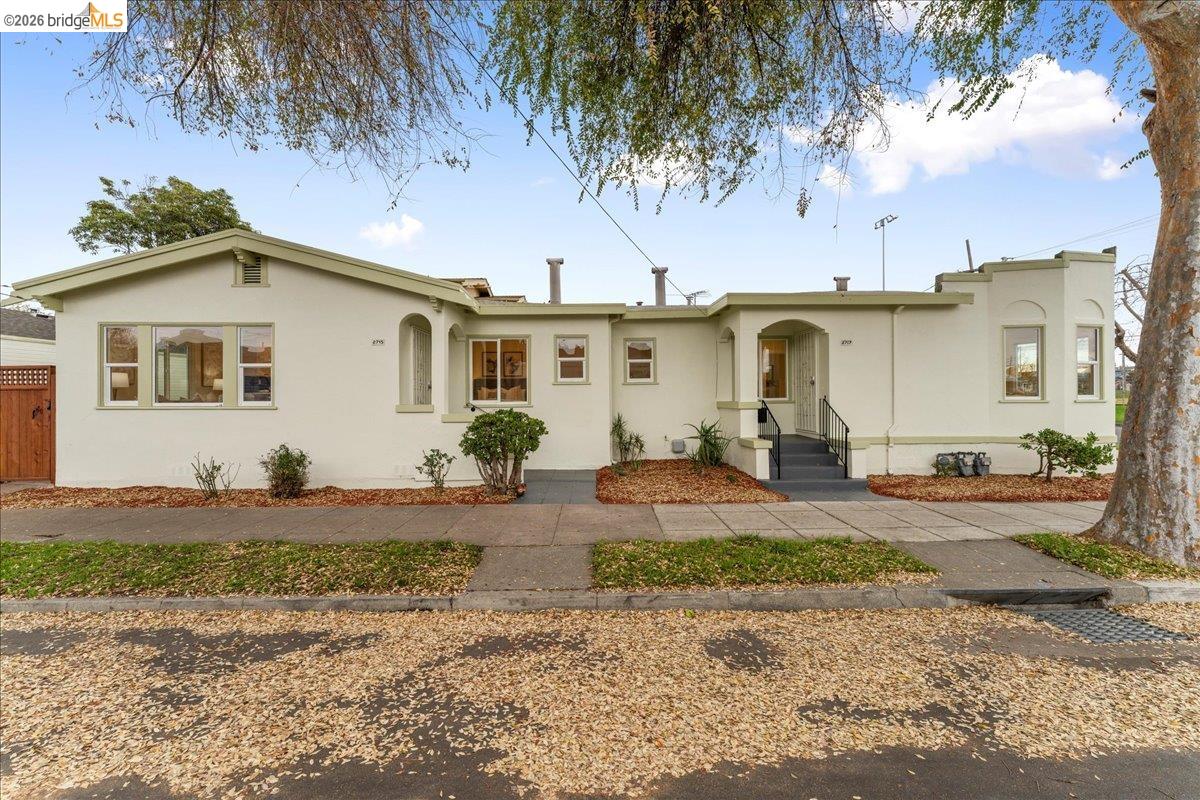 2717 Mabel Street Berkeley, CA 94702 - Photo 50 of 60 a view of a white house with a large tree next to a road