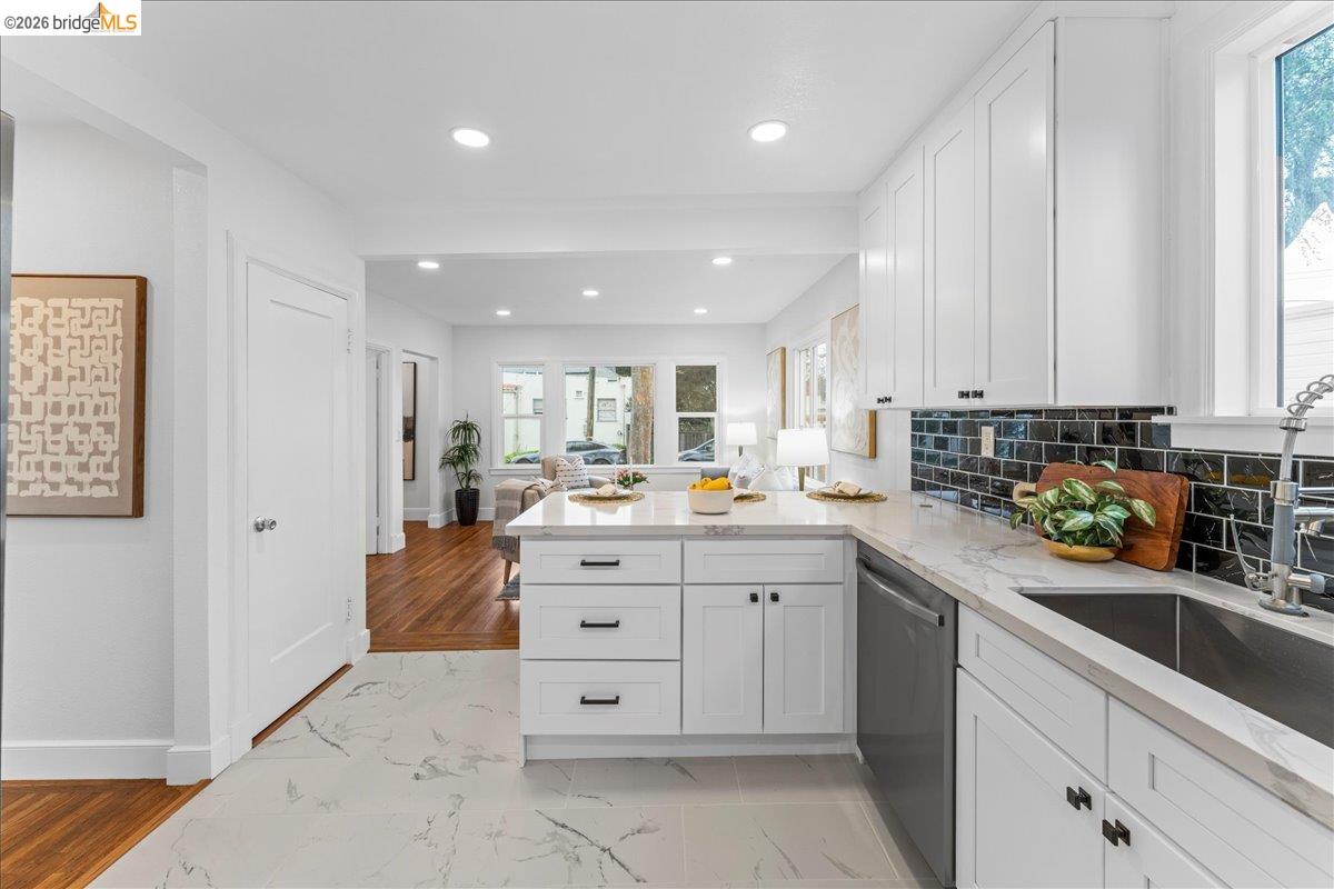 2717 Mabel Street Berkeley, CA 94702 - Photo 5 of 60 a kitchen with stainless steel appliances kitchen island granite countertop a sink window and cabinets
