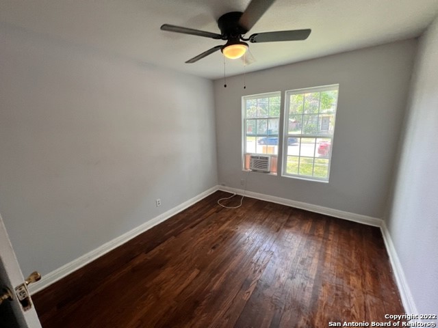 513 Walton Avenue San Antonio, TX 78225 - Photo 4 of 11 a view of an empty room with wooden floor and a window