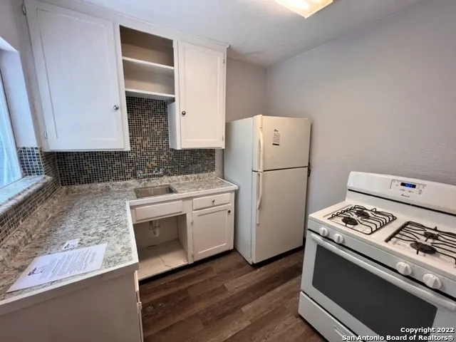 a kitchen with a stove and a refrigerator