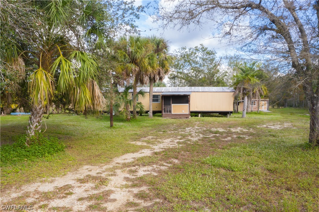 47710 Bermont Road Punta Gorda, FL 33982 - Photo 1 of 40 a view of a house with backyard and tree