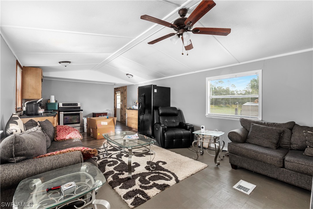 47710 Bermont Road Punta Gorda, FL 33982 - Photo 23 of 40 a living room with furniture a ceiling fan and a window