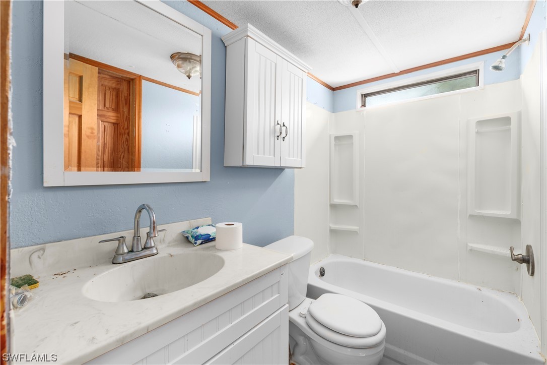 47710 Bermont Road Punta Gorda, FL 33982 - Photo 32 of 40 a bathroom with a sink toilet and shower