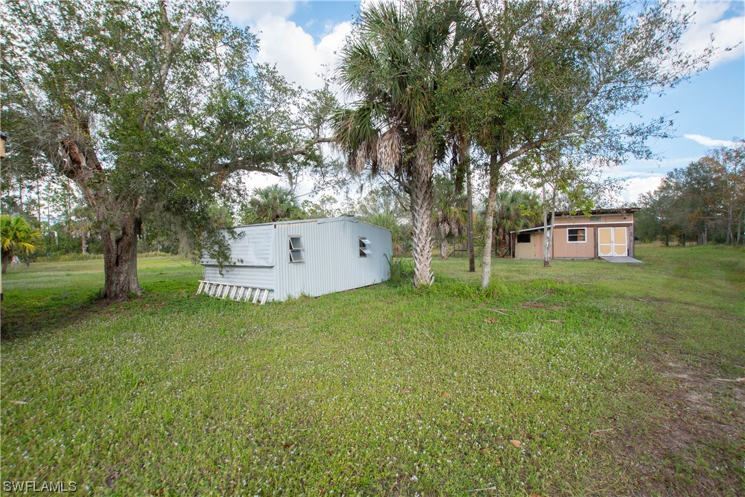47710 Bermont Road Punta Gorda, FL 33982 - Photo 34 of 40 a view of a house with backyard and a tree