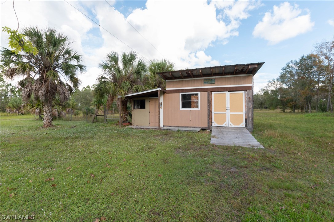 47710 Bermont Road Punta Gorda, FL 33982 - Photo 38 of 40 a front view of house with yard and trees