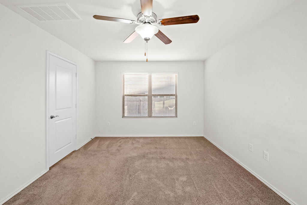 3621 Colorado High Avenue Austin, TX 78744 - Photo 14 of 40 an empty room with windows and fan
