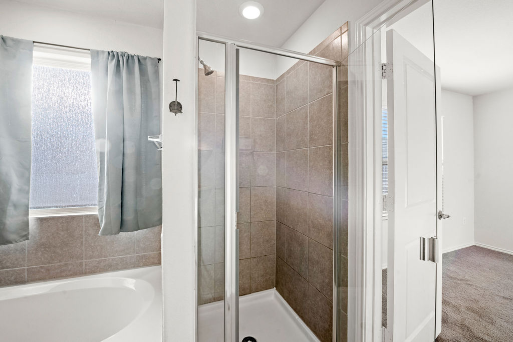 3621 Colorado High Avenue Austin, TX 78744 - Photo 25 of 40 a bathroom with a shower and a glass door shower