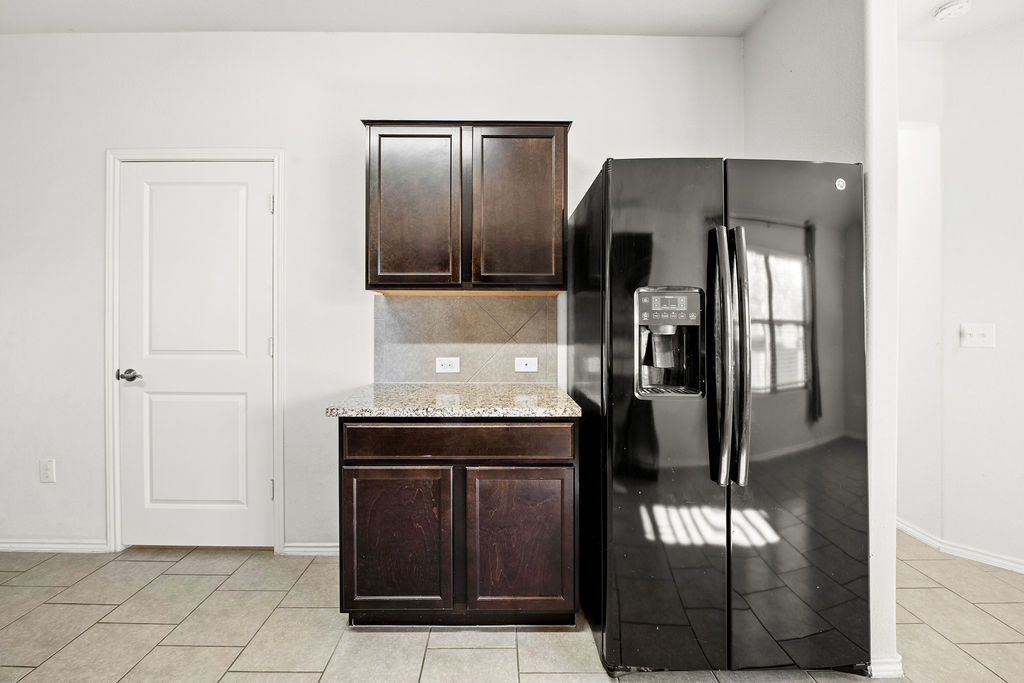 3621 Colorado High Avenue Austin, TX 78744 - Photo 31 of 40 a kitchen with a refrigerator and cabinets