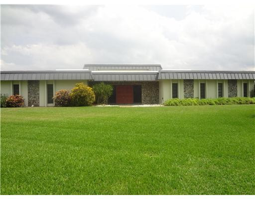 6000 Melaleuca Road Southwest Ranches, FL 33330 - Photo 1 of 19 a front view of house with yard and green space