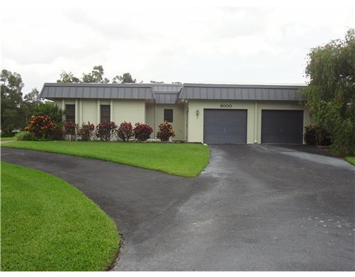6000 Melaleuca Road Southwest Ranches, FL 33330 - Photo 2 of 19 a view of a house with a yard and plants