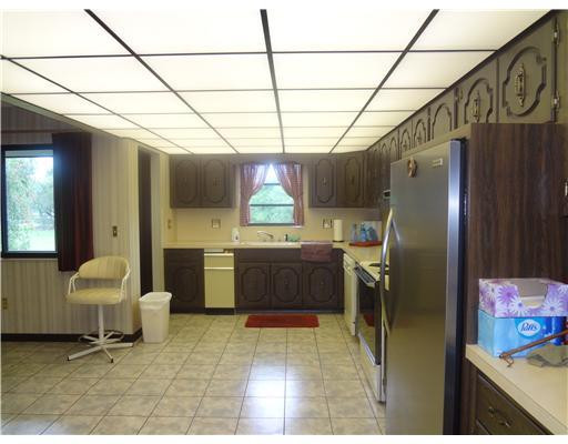 6000 Melaleuca Road Southwest Ranches, FL 33330 - Photo 7 of 19 a kitchen with stainless steel appliances kitchen island granite countertop lots of counter top space and furniture