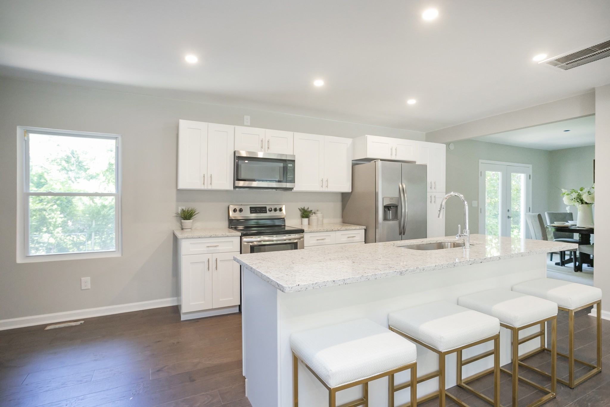 2966 Anderson Road Nashville, TN 37217 - Photo 16 of 23 a kitchen with stainless steel appliances granite countertop a stove a sink a refrigerator a microwave oven with a dining table and chairs