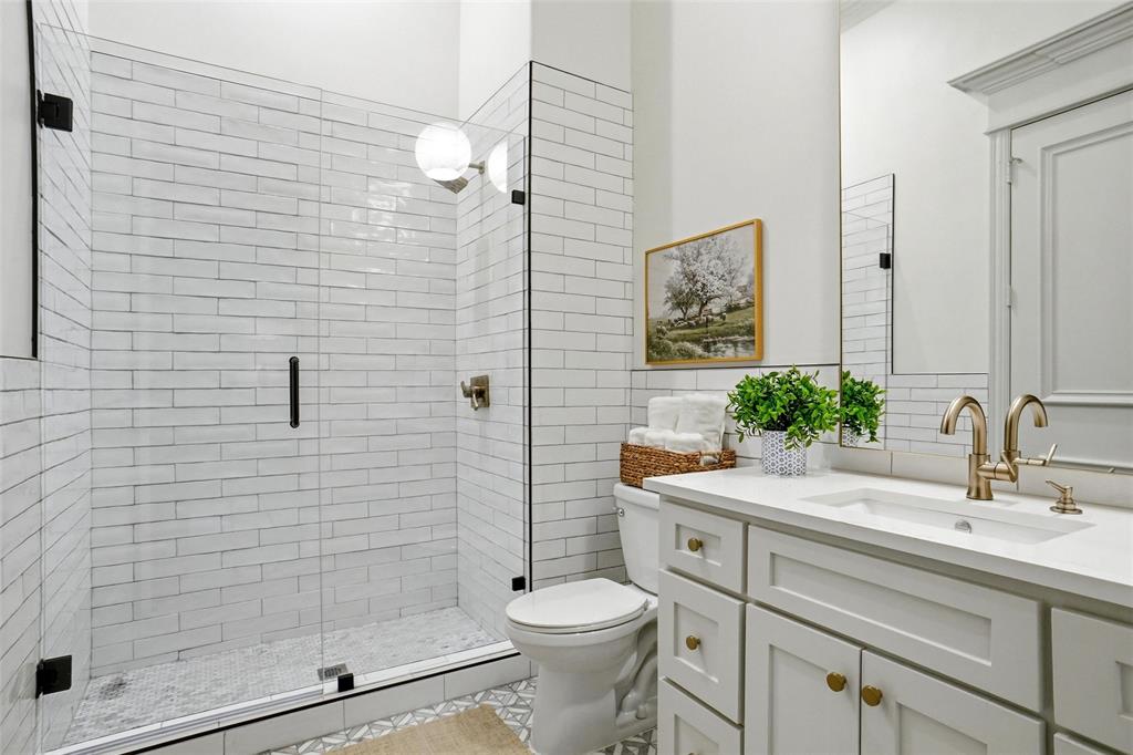 509 King Ranch Road Southlake, TX 76092 - Photo 22 of 40 a bathroom with a sink toilet and shower