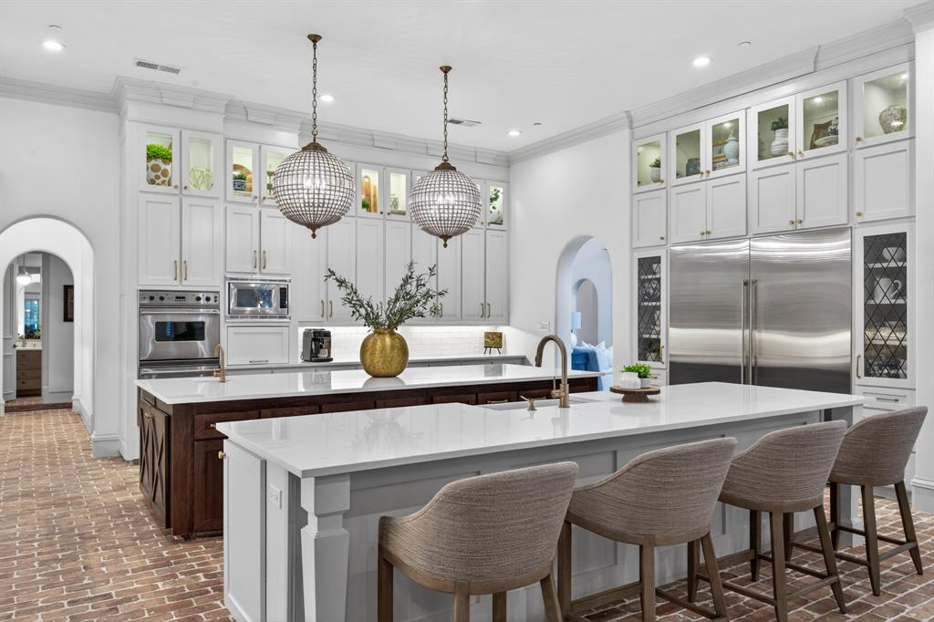 509 King Ranch Road Southlake, TX 76092 - Photo 3 of 40 a kitchen with stainless steel appliances kitchen island granite countertop a table chairs and a chandelier