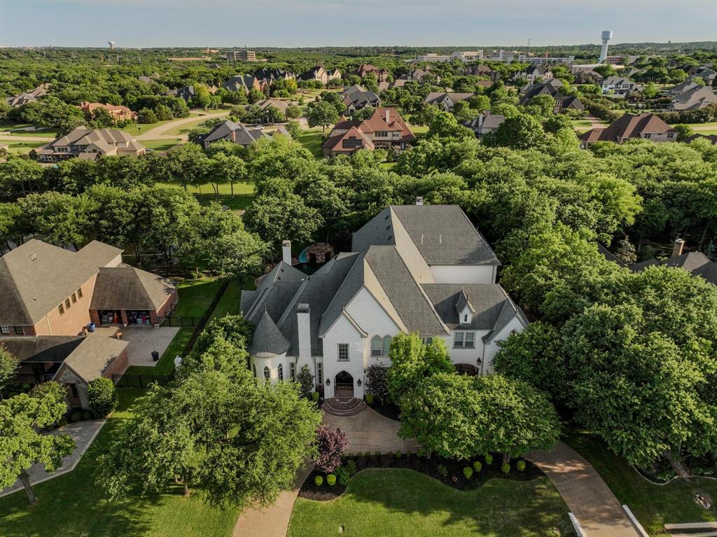 509 King Ranch Road Southlake, TX 76092 - Photo 36 of 36 Gable-roof property featuring a light-colored facade, multiple chimneys, and a prominent front entrance with a curved driveway