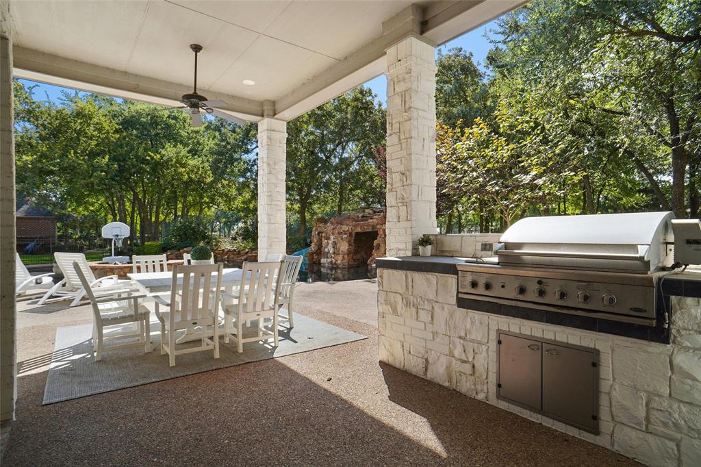 509 King Ranch Road Southlake, TX 76092 - Photo 36 of 40 a view of a patio with a table chairs and a floor to ceiling window