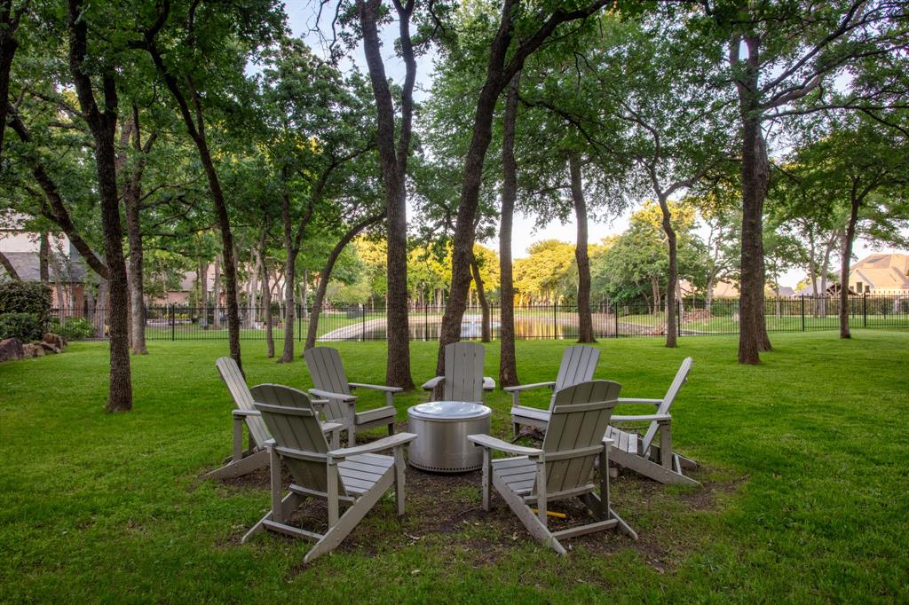 509 King Ranch Road Southlake, TX 76092 - Photo 39 of 40 Expansive lawn area featuring mature trees and a tranquil water feature