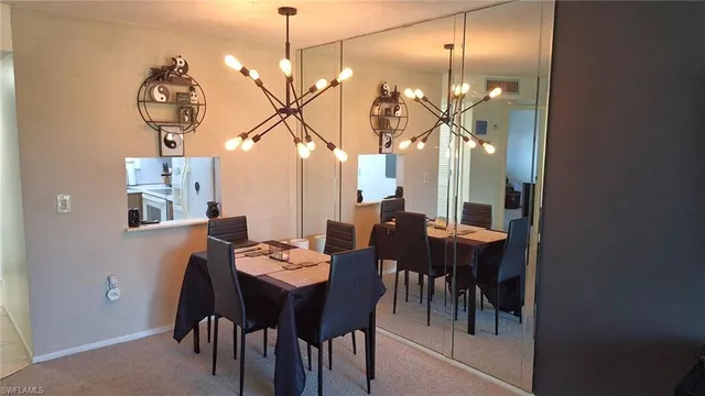 a view of a dining room with furniture and chandelier