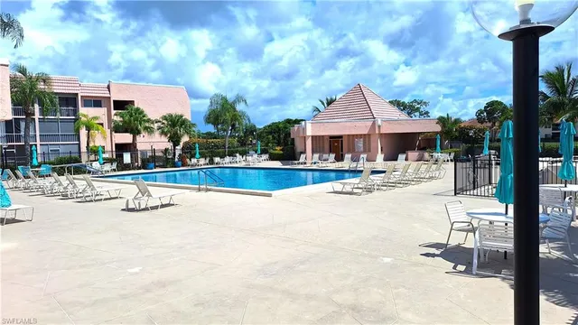 a view of a house with swimming pool and sitting area