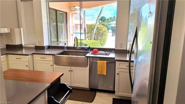 a kitchen with a sink and a refrigerator