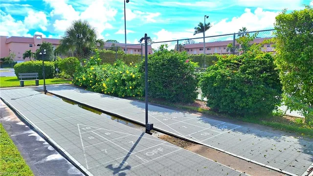 a view of a street with potted plants