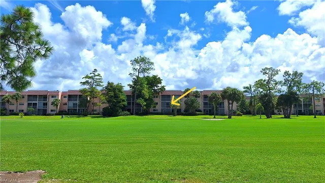 a view of a building in front of the house and trees