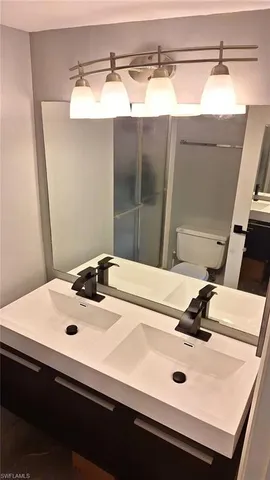 a bathroom with a sink and mirror