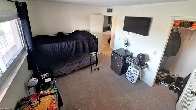 a bedroom with bed and a window