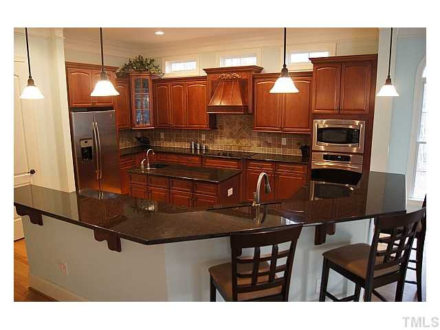 3740 Mason Road New Hill, NC 27562 - Photo 3 of 20 Gourmet kitchen with granite counters, stainless steel appliances, walk-in pantry, & large island/bar Kitchen