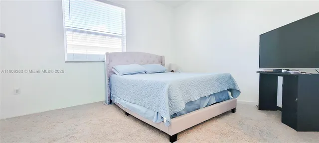 a bathroom with a sink a toilet and shower curtain