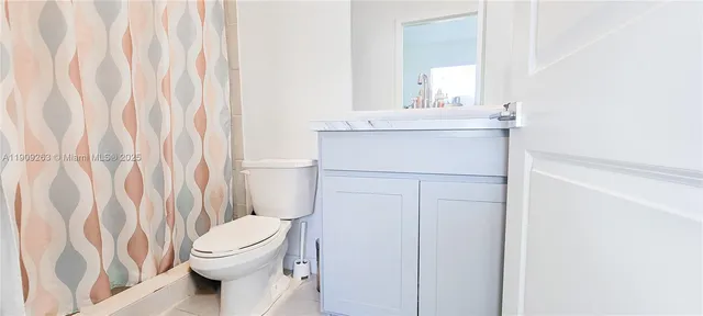 a bedroom with two beds and a chair