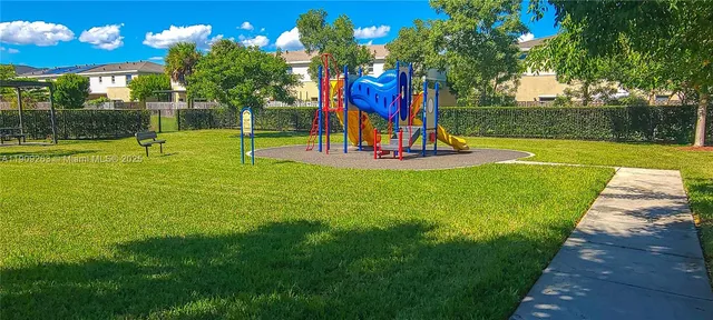 a view of a livingroom with wooden floor and furniture