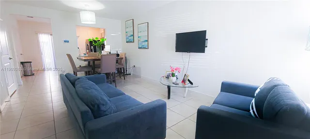 a living room with furniture and a flat screen tv
