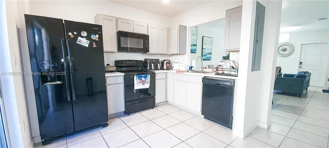 a kitchen with stainless steel appliances granite countertop a refrigerator stove and sink
