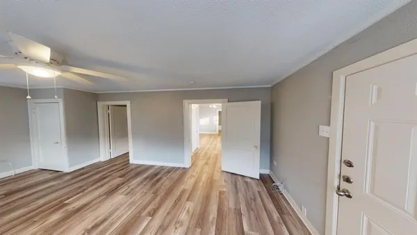 a view of a room with wooden floor and bathroom