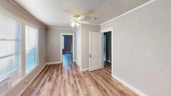 a view of a room with wooden floor and window
