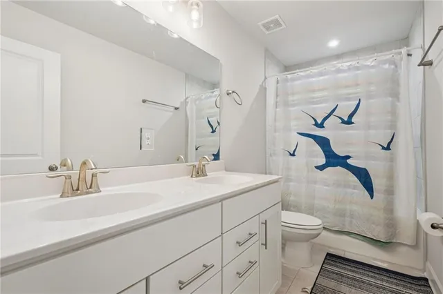 a bathroom with a sink toilet and a mirror