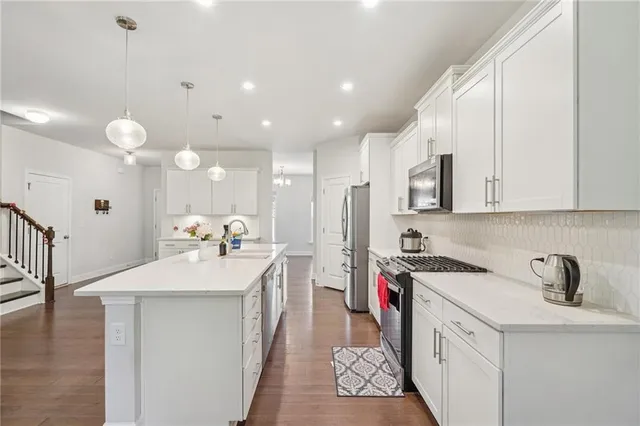 a kitchen with a sink stove and cabinets