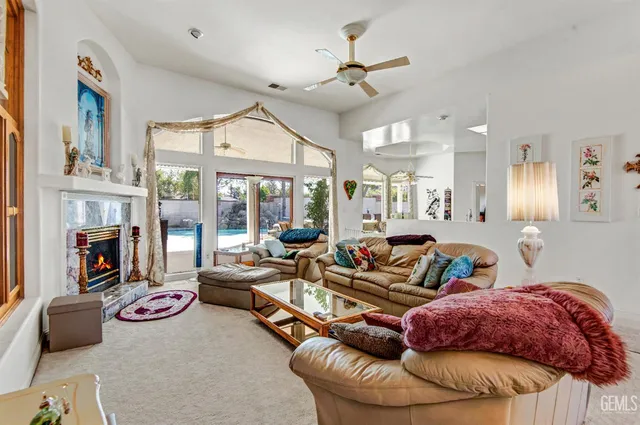 a living room with furniture fireplace and a chandelier